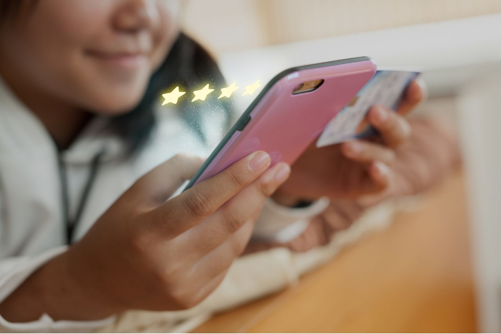 Two girls sitting on a bench outside, leaning forward to look at a phone